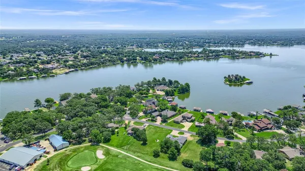 an aerial view of lake and residential houses with outdoor space