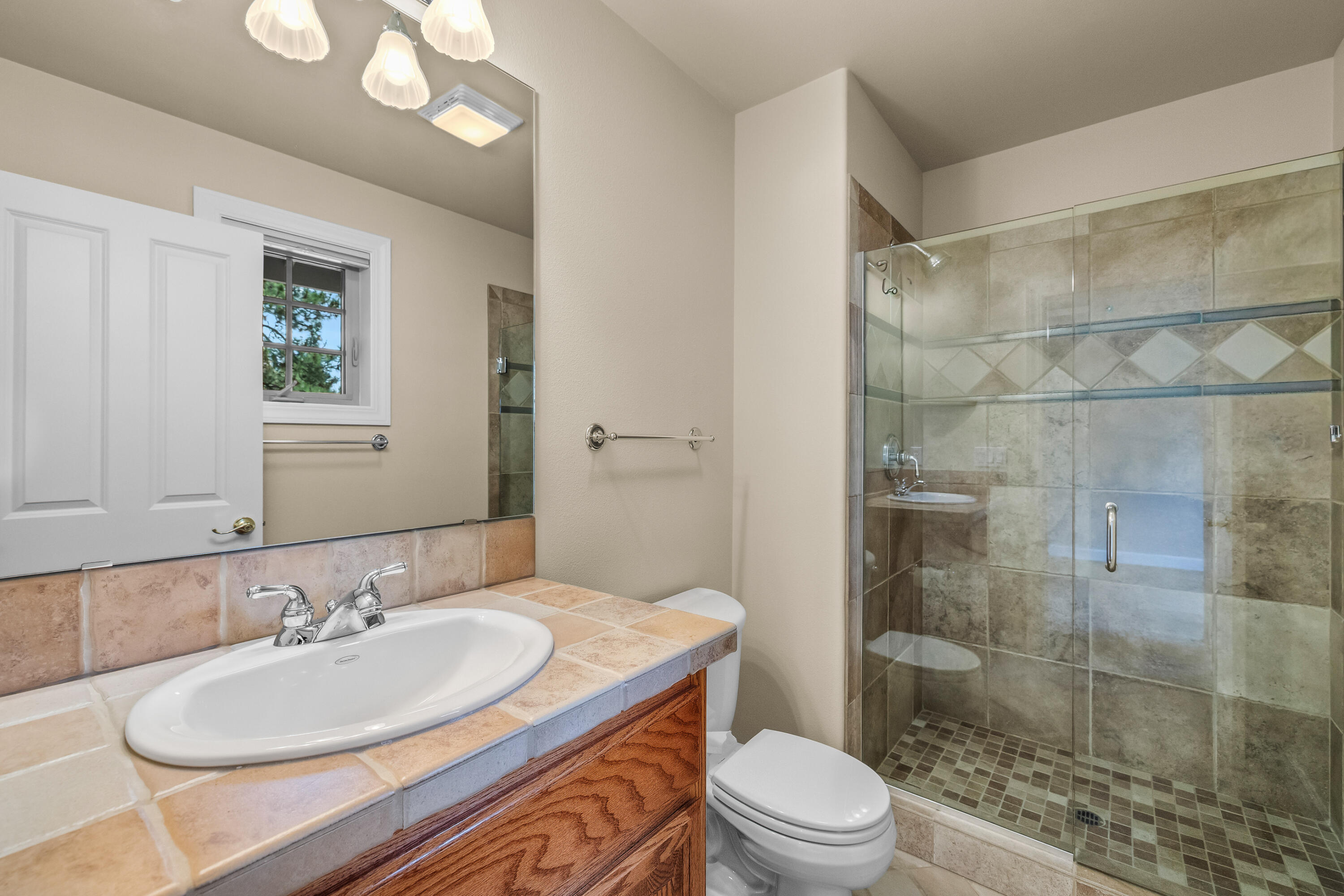 19598 Green Lakes Loop Bend, OR 97702 - Photo 49 of 89 a bathroom with a sink a toilet and shower