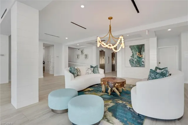 a living room with furniture chandelier and a chandelier