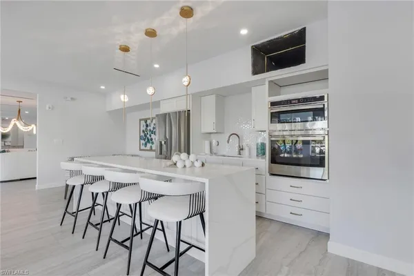 a kitchen with a sink a center island a counter space and a window