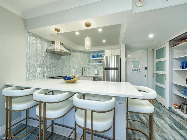 a kitchen with a table and chairs in it