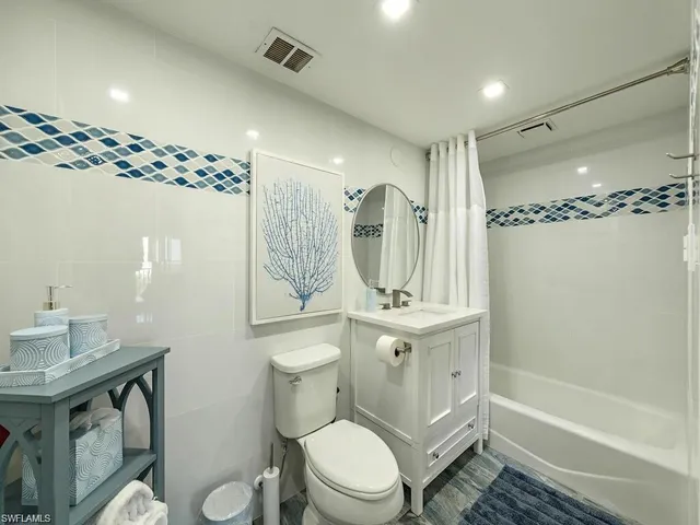 a bathroom with a sink toilet a mirror and shower