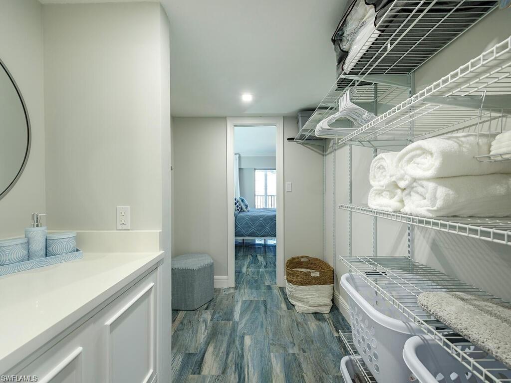 1 Bluebill Avenue, Unit 703 Naples, FL 34108 - Photo 10 of 31 a bathroom with a granite countertop sink a toilet and bathtub