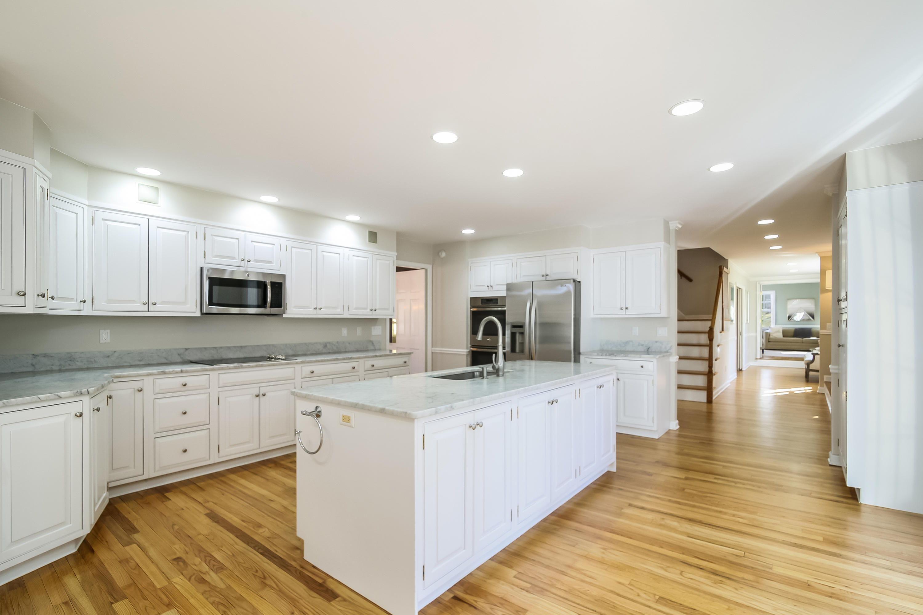 228 Laurel Road New Canaan, CT 06840 - Photo 11 of 38 a large kitchen with stainless steel appliances kitchen island a large counter top and a wooden floors