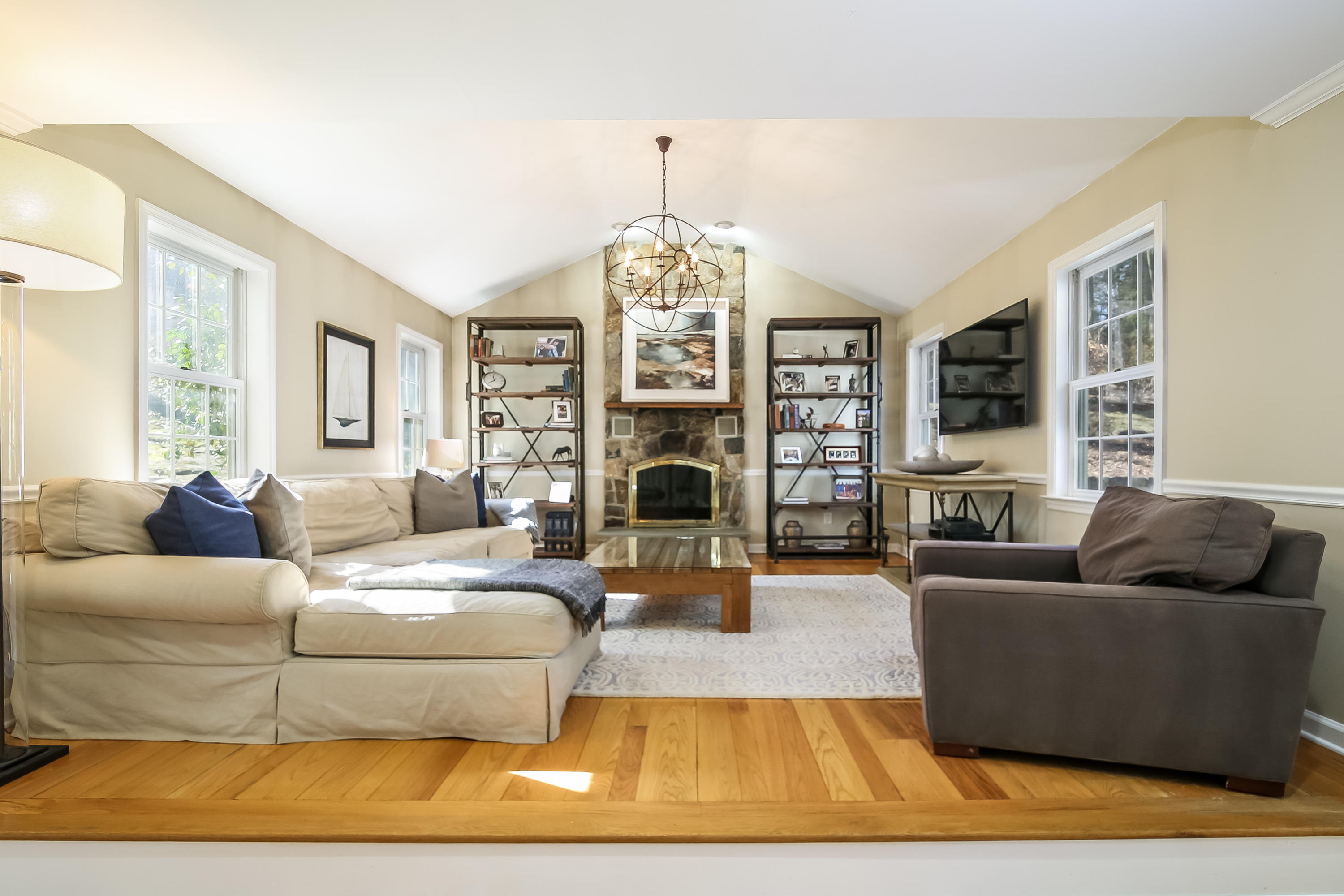 228 Laurel Road New Canaan, CT 06840 - Photo 13 of 38 a living room with fireplace furniture and a chandelier