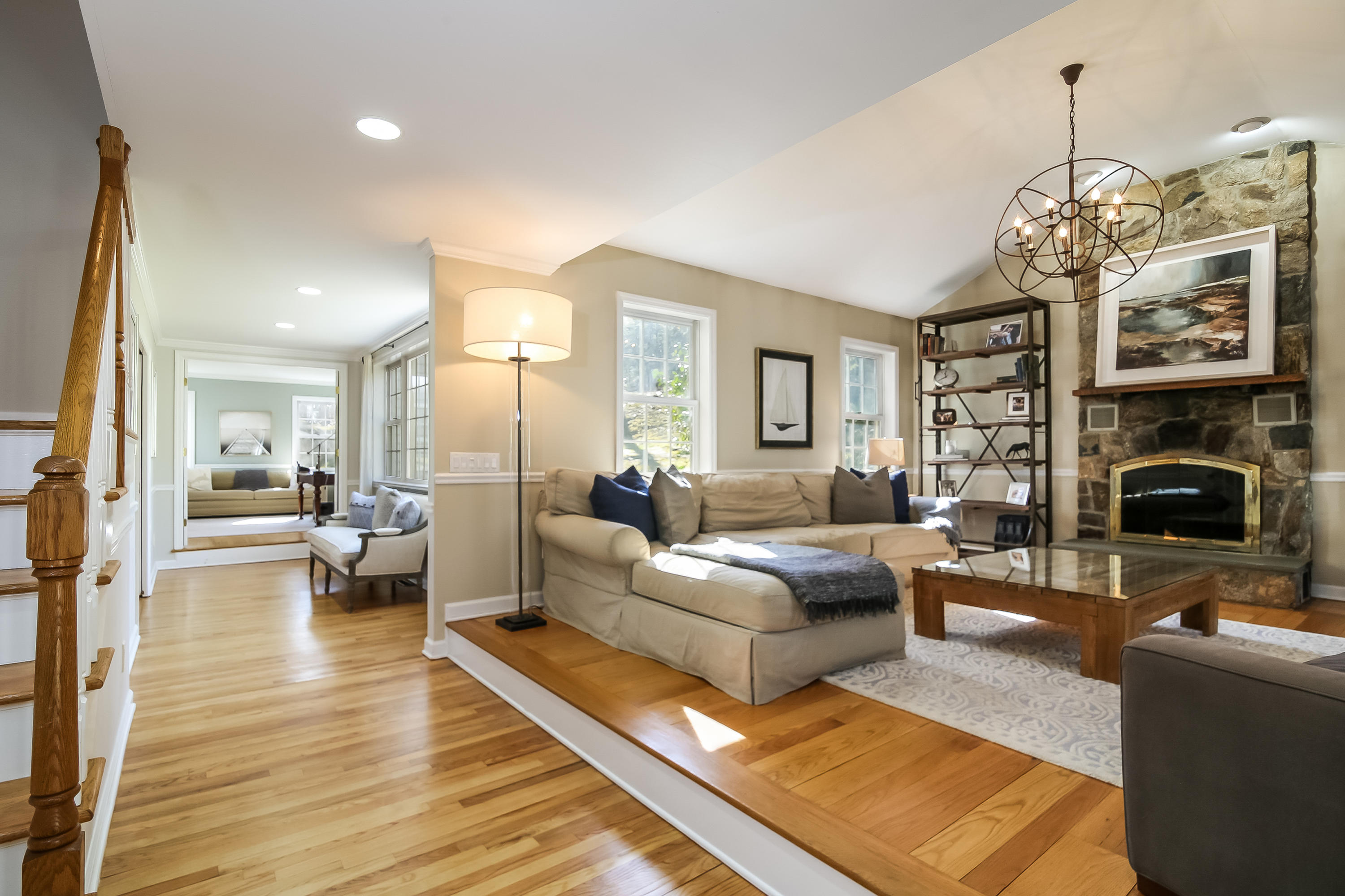228 Laurel Road New Canaan, CT 06840 - Photo 15 of 38 a living room with fireplace furniture and a chandelier
