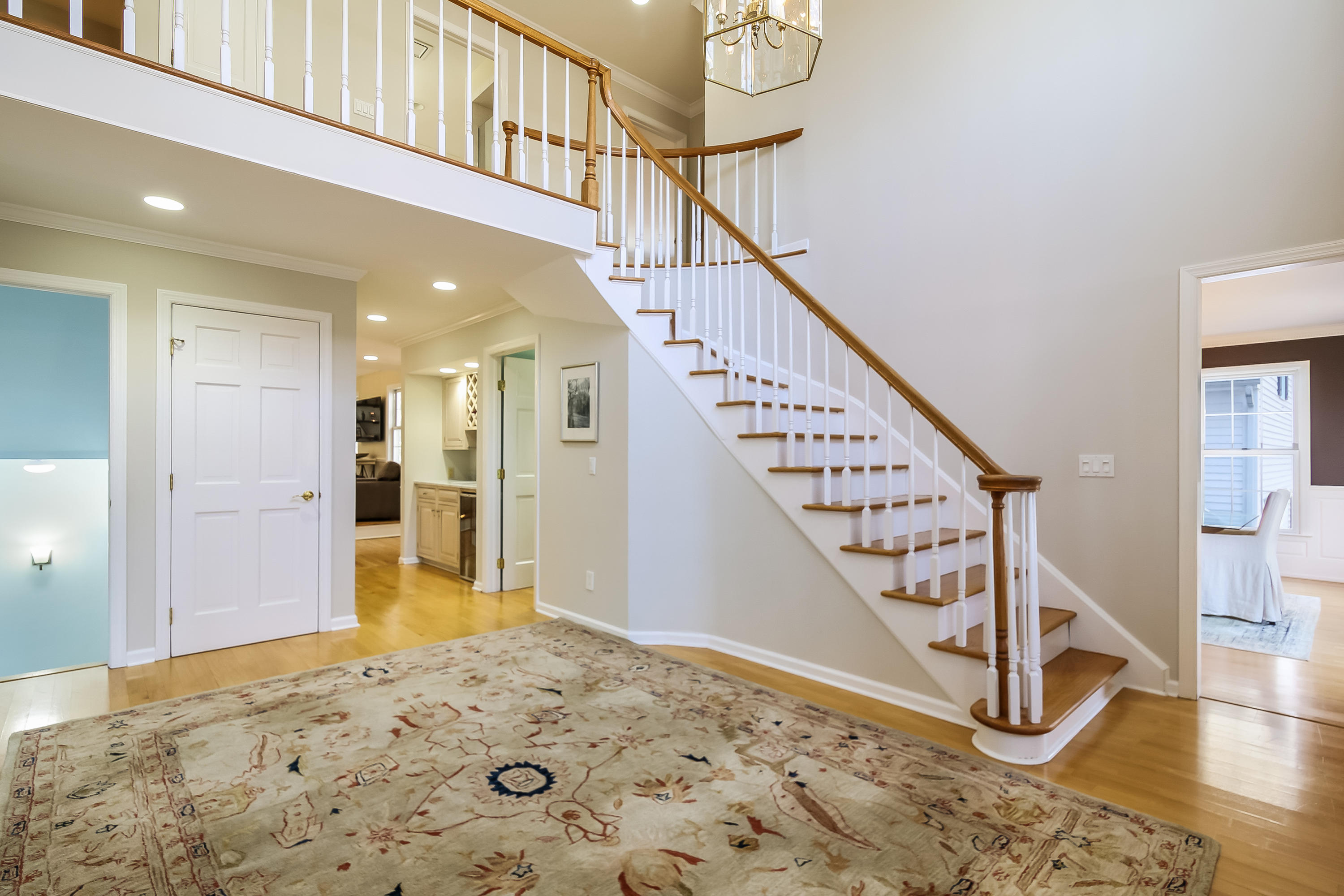 228 Laurel Road New Canaan, CT 06840 - Photo 2 of 38 a view of a hallway with wooden floor and stairs