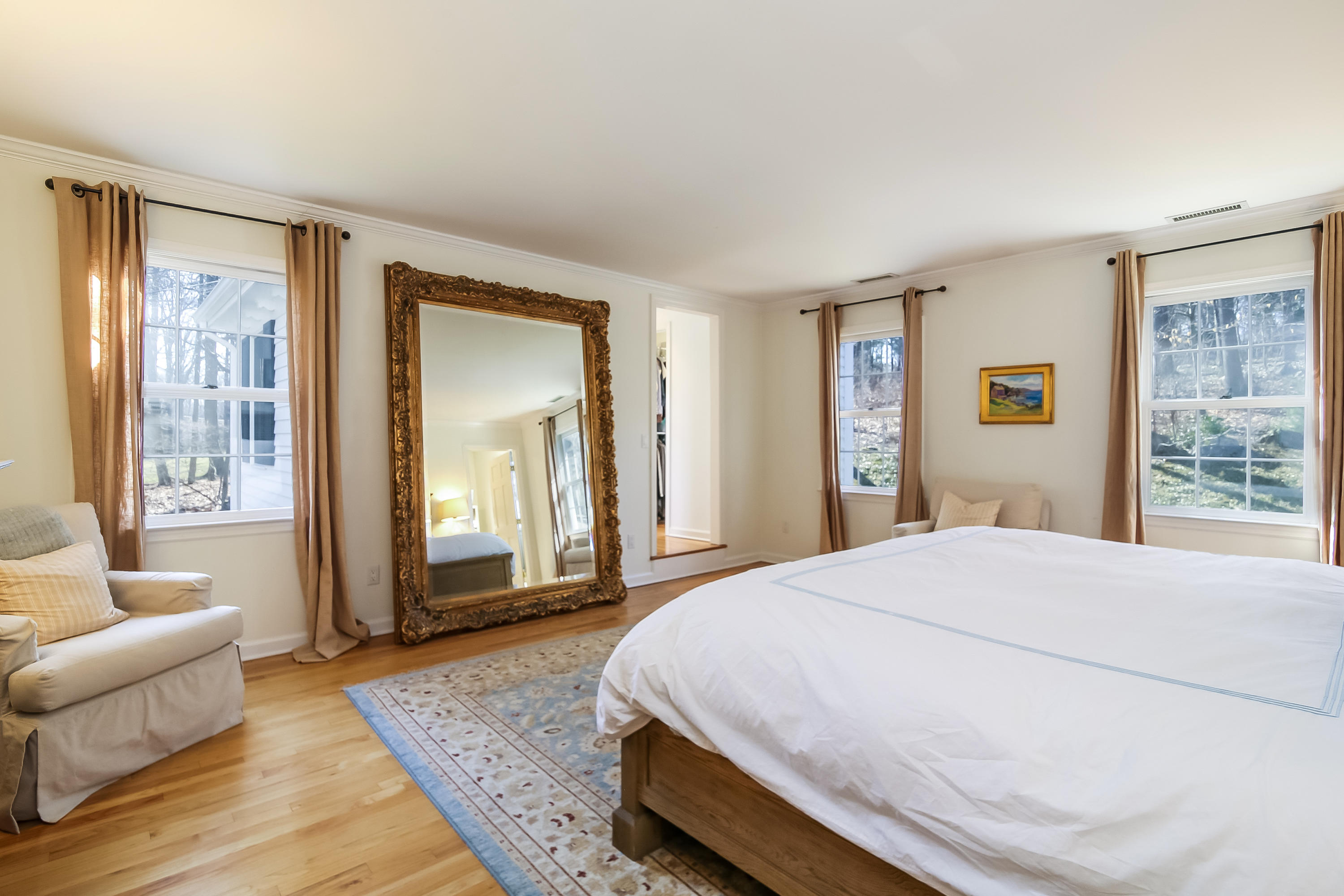 228 Laurel Road New Canaan, CT 06840 - Photo 22 of 38 a spacious bedroom with a bed and glass window