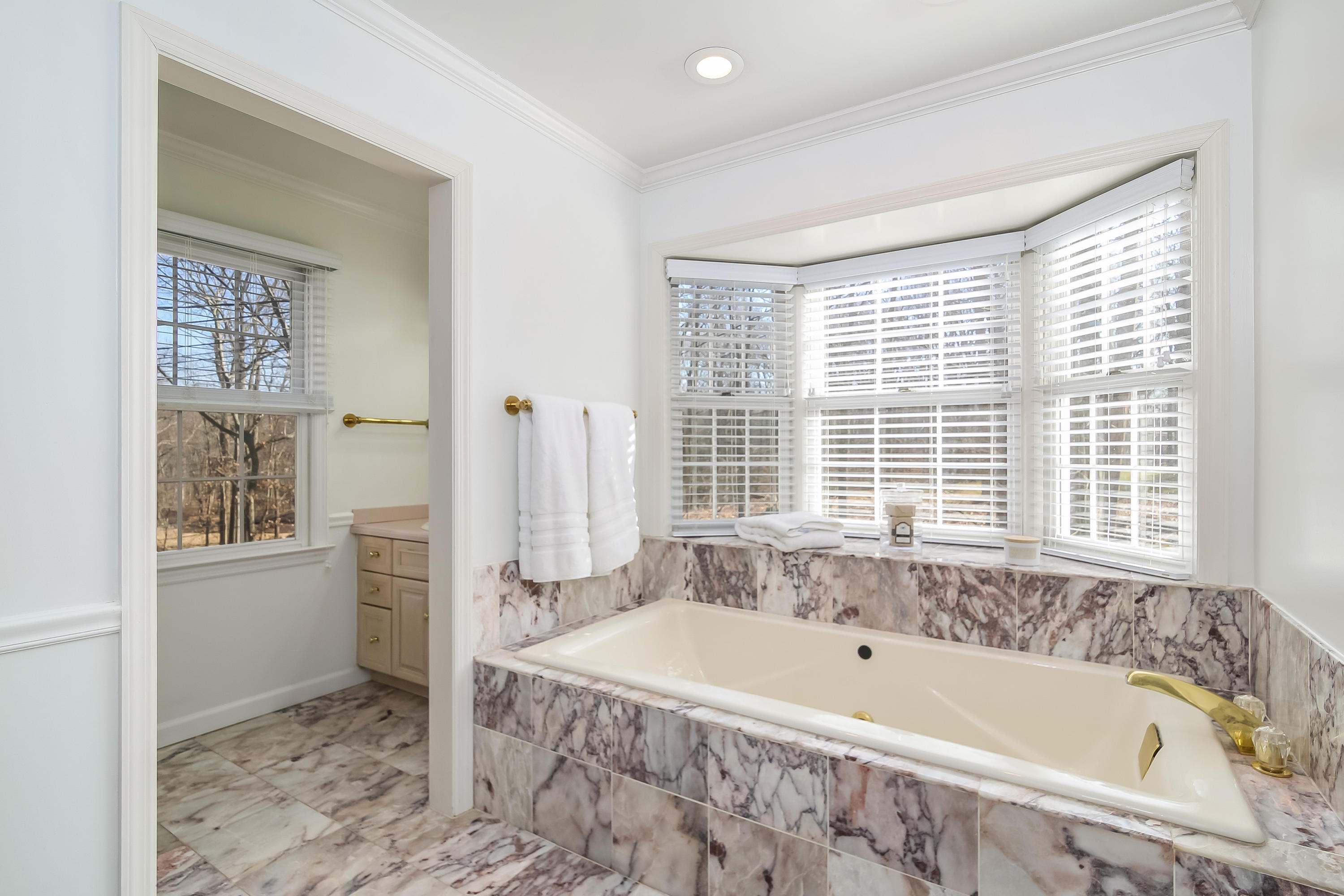 228 Laurel Road New Canaan, CT 06840 - Photo 24 of 38 a bath tub sitting in a bathroom next to a window