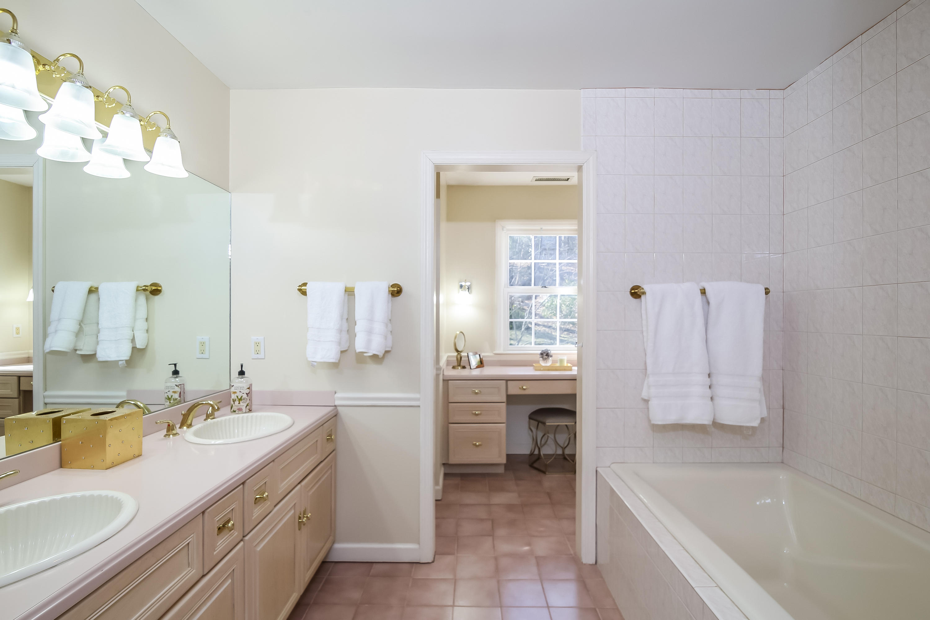 228 Laurel Road New Canaan, CT 06840 - Photo 28 of 38 a bathroom with a tub sink and mirror