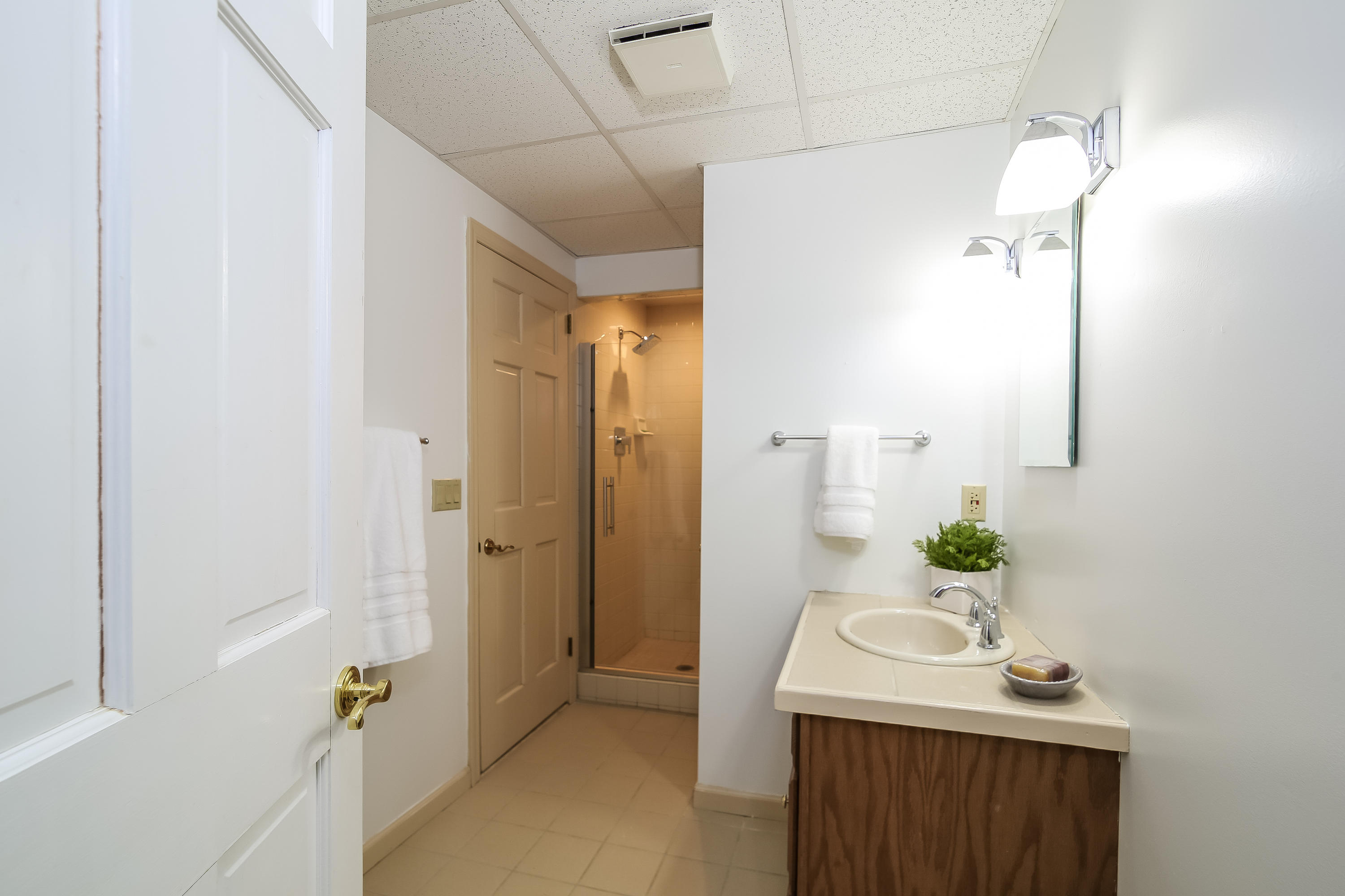 228 Laurel Road New Canaan, CT 06840 - Photo 32 of 38 a bathroom with a sink a mirror and shower