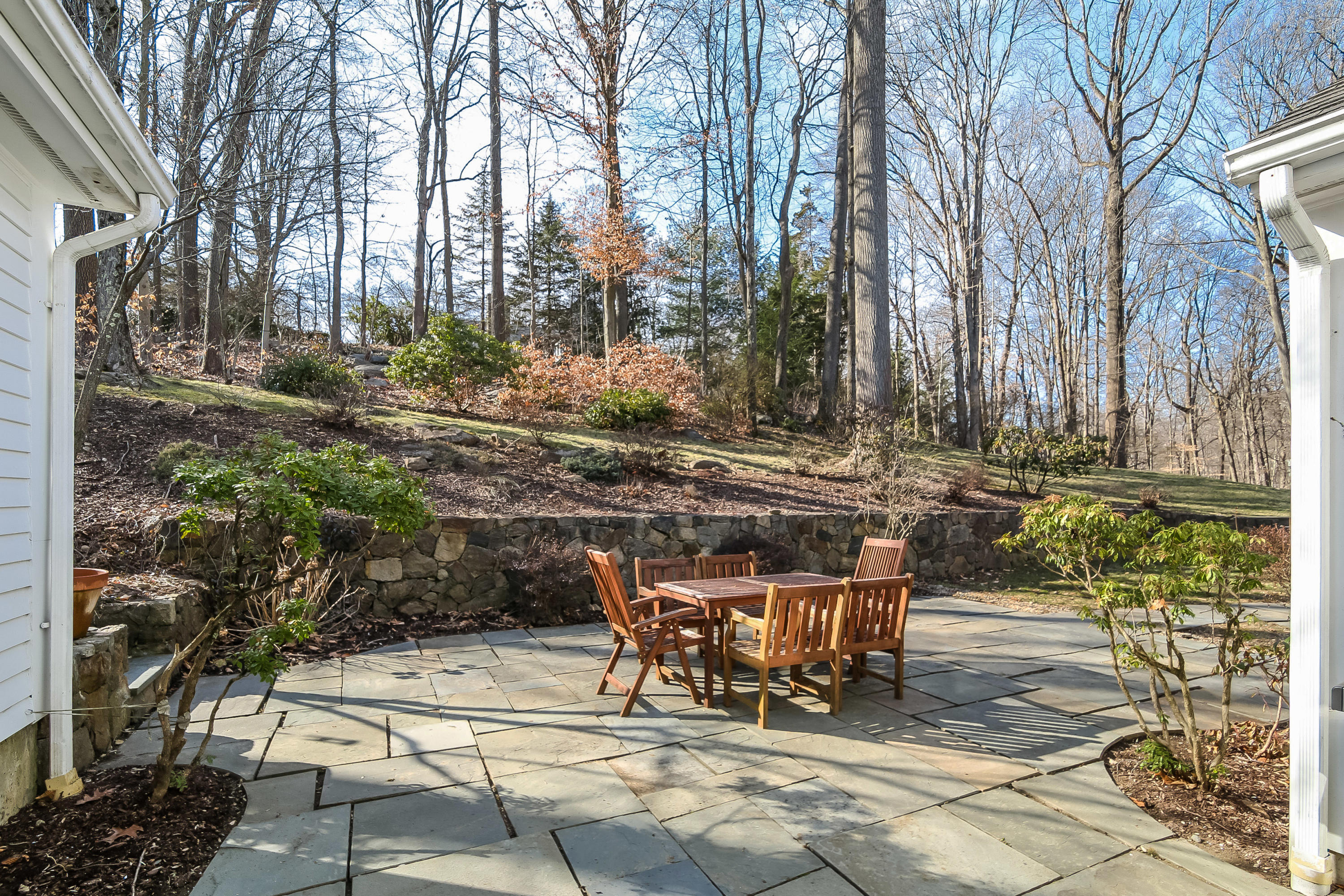 228 Laurel Road New Canaan, CT 06840 - Photo 34 of 38 a view of a patio with table and chairs and potted plants