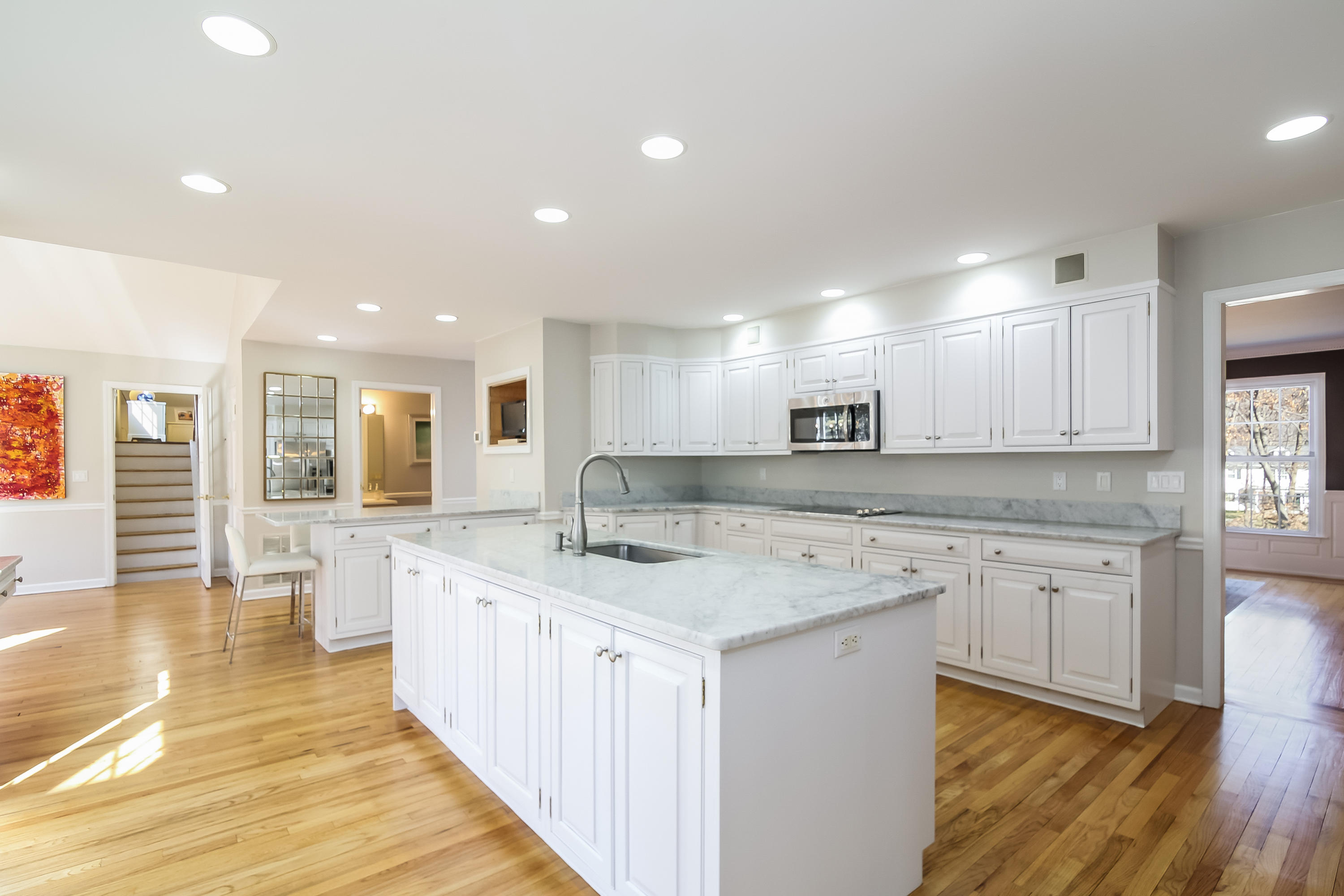 228 Laurel Road New Canaan, CT 06840 - Photo 8 of 38 a large kitchen with stainless steel appliances granite countertop a sink and cabinets