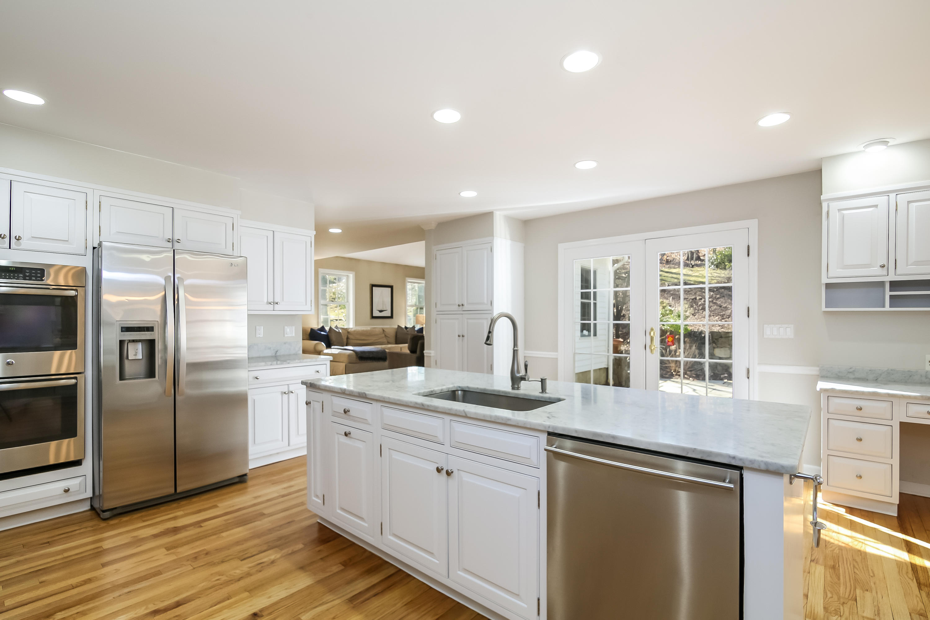 228 Laurel Road New Canaan, CT 06840 - Photo 10 of 38 a kitchen with a sink stove and refrigerator