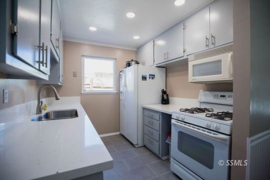 246 Peg Street Ridgecrest, CA 93555 - Photo 7 of 30 a kitchen with cabinets and steel stainless steel appliances