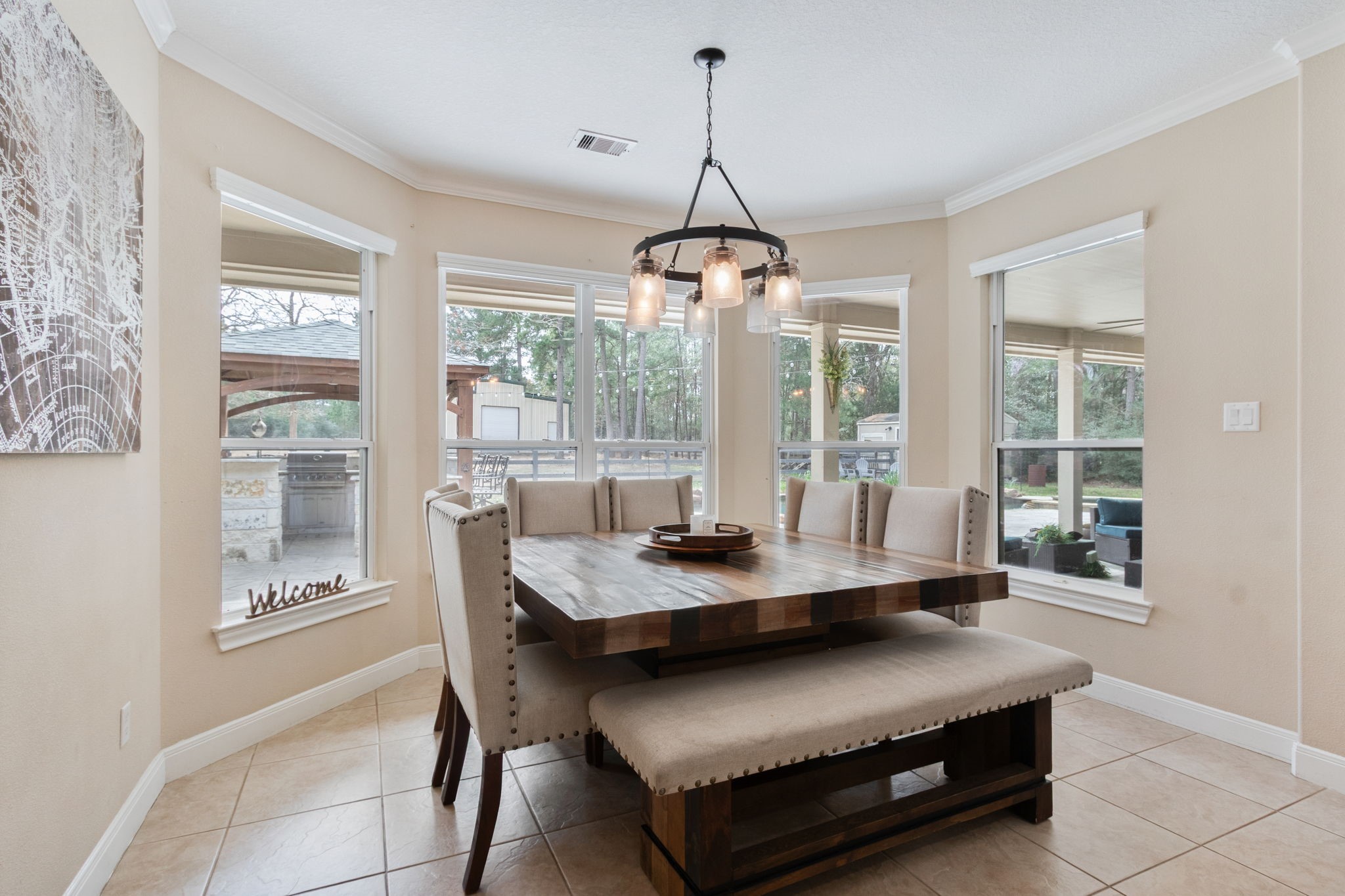 26231 Crown Ranch Boulevard Montgomery, TX 77316 - Photo 13 of 46 a dining room with wooden floor a chandelier a wooden table and chairs