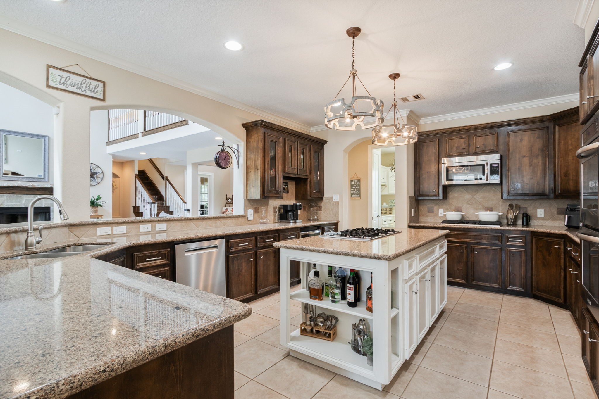 26231 Crown Ranch Boulevard Montgomery, TX 77316 - Photo 14 of 46 a kitchen with a stove sink and cabinets