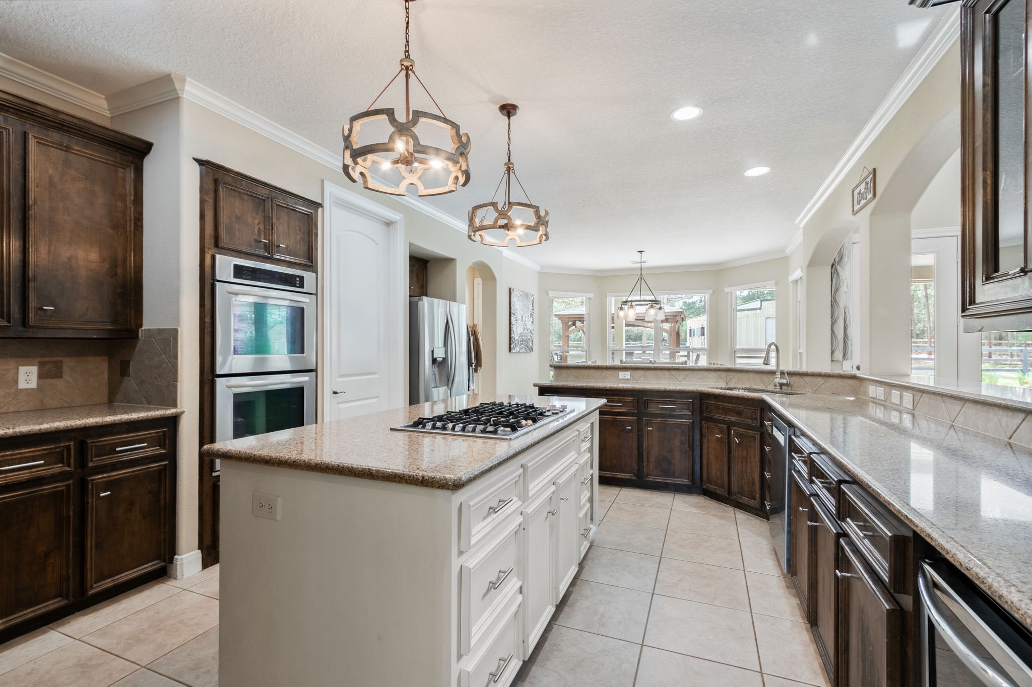 26231 Crown Ranch Boulevard Montgomery, TX 77316 - Photo 16 of 46 a kitchen with stainless steel appliances granite countertop a stove and a sink