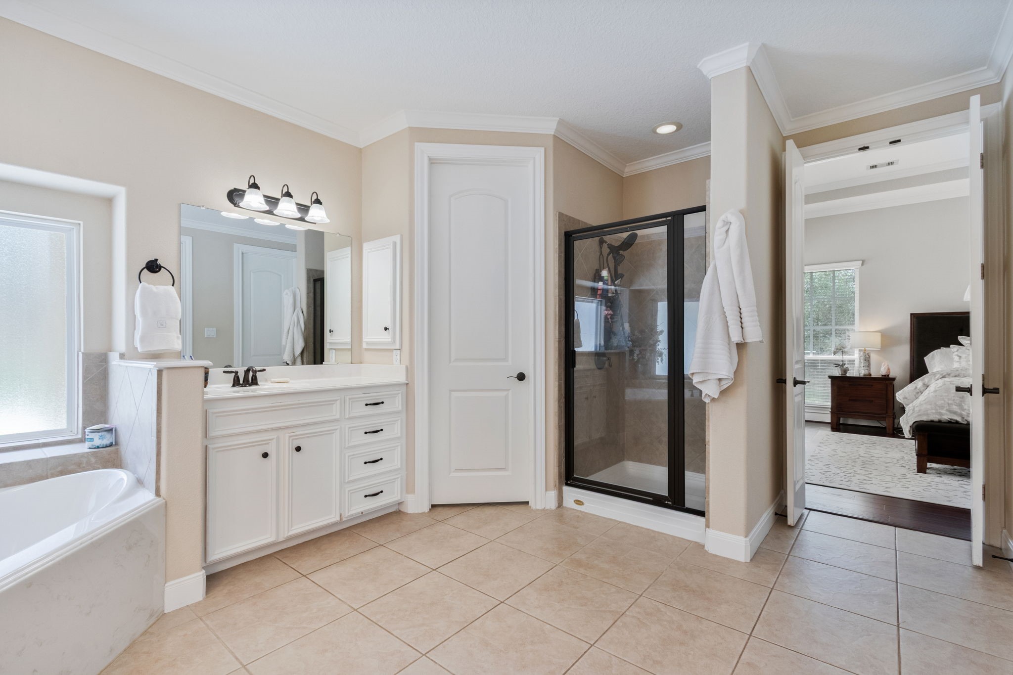 26231 Crown Ranch Boulevard Montgomery, TX 77316 - Photo 20 of 46 a spacious bathroom with a double vanity sink shower and a mirror