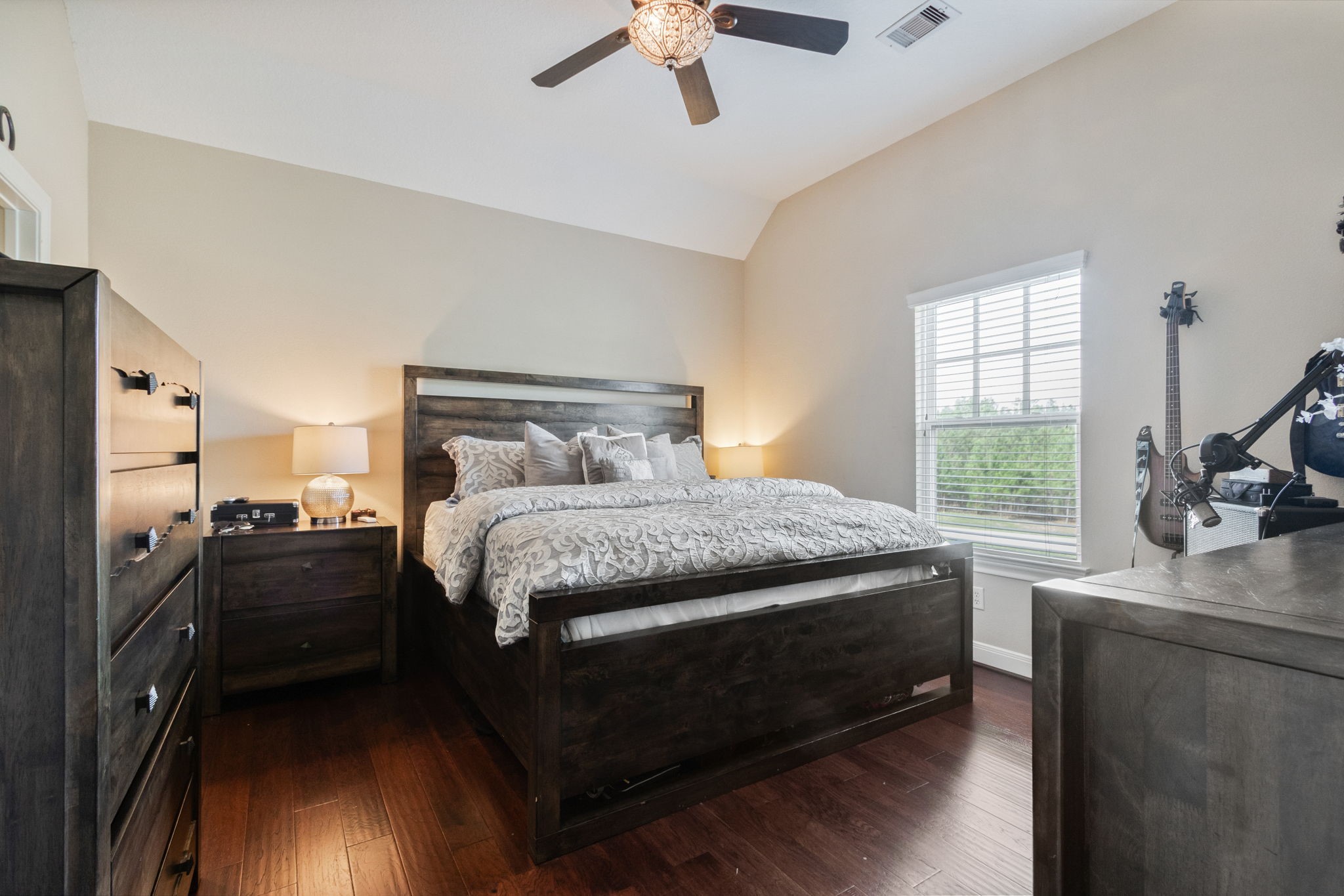 26231 Crown Ranch Boulevard Montgomery, TX 77316 - Photo 21 of 46 a bedroom with a bed and a chandelier