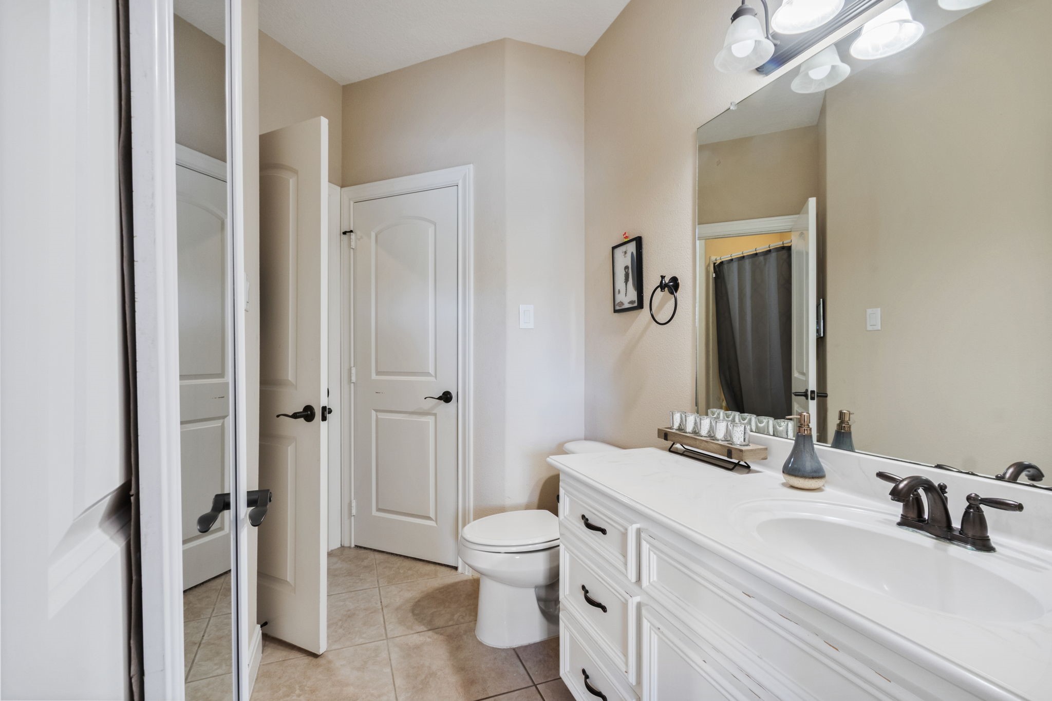 26231 Crown Ranch Boulevard Montgomery, TX 77316 - Photo 22 of 46 a bathroom with a double vanity sink toilet mirror and shower