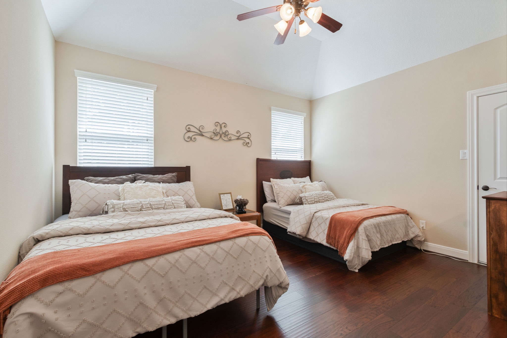 26231 Crown Ranch Boulevard Montgomery, TX 77316 - Photo 23 of 46 a bedroom with two beds and a chandelier