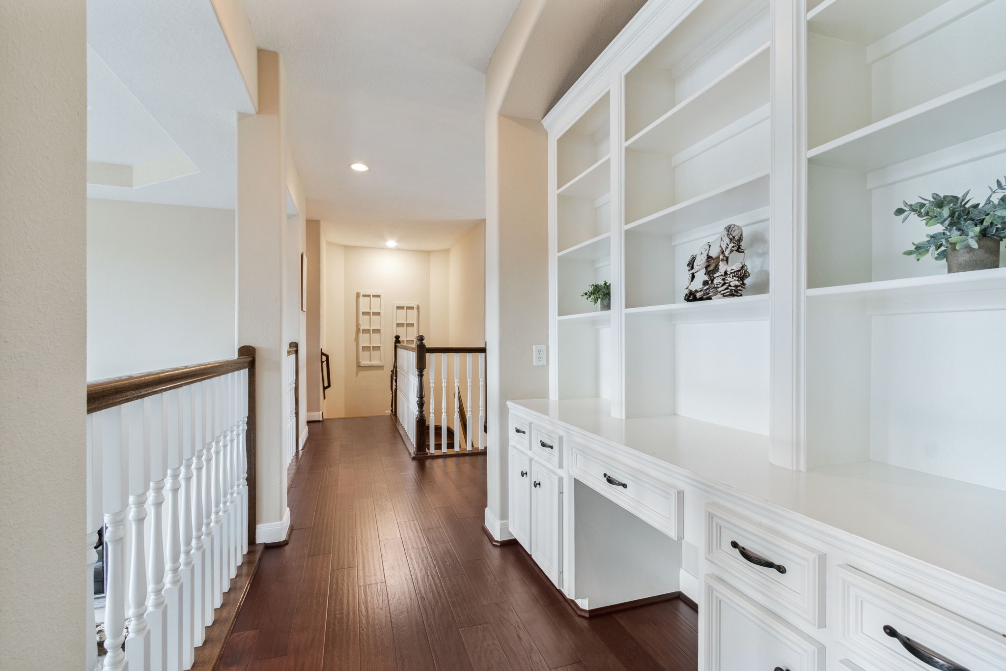 26231 Crown Ranch Boulevard Montgomery, TX 77316 - Photo 27 of 46 a hallway with white cabinets and wooden floor