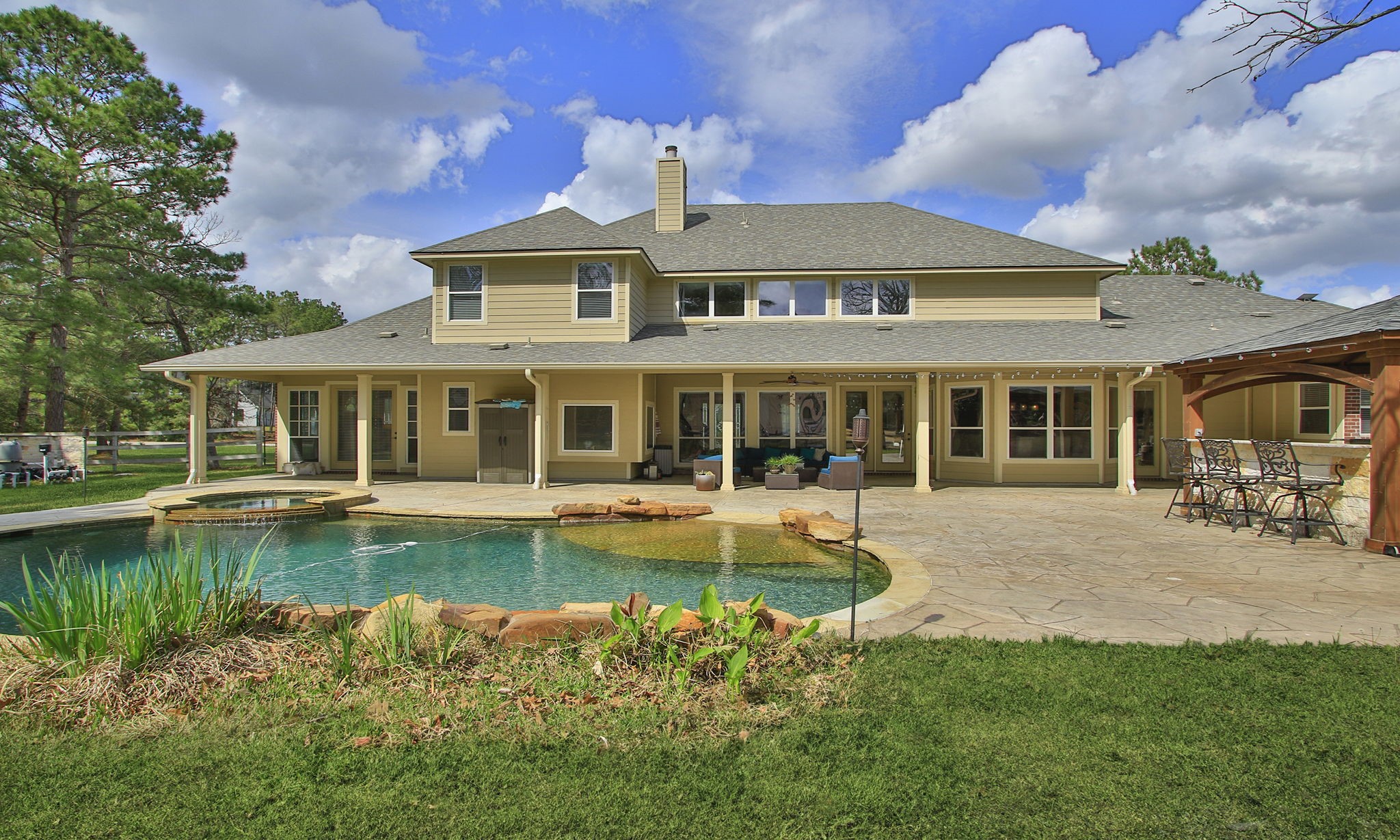 26231 Crown Ranch Boulevard Montgomery, TX 77316 - Photo 35 of 46 a front view of a house with swimming pool having outdoor seating