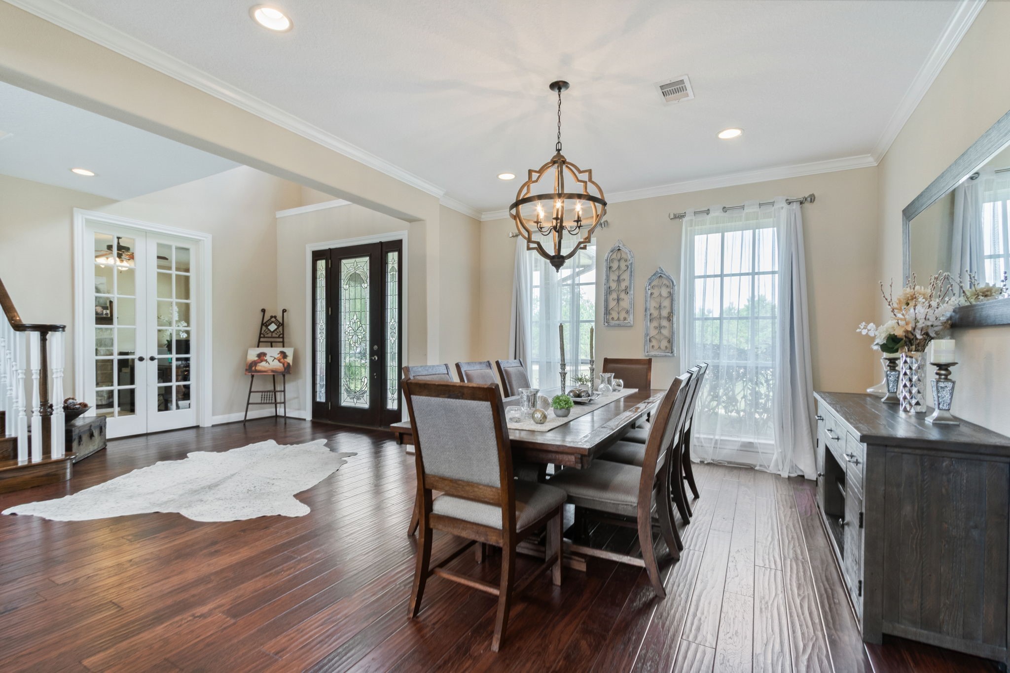 26231 Crown Ranch Boulevard Montgomery, TX 77316 - Photo 9 of 46 a view of a dining room with furniture wooden floor and chandelier