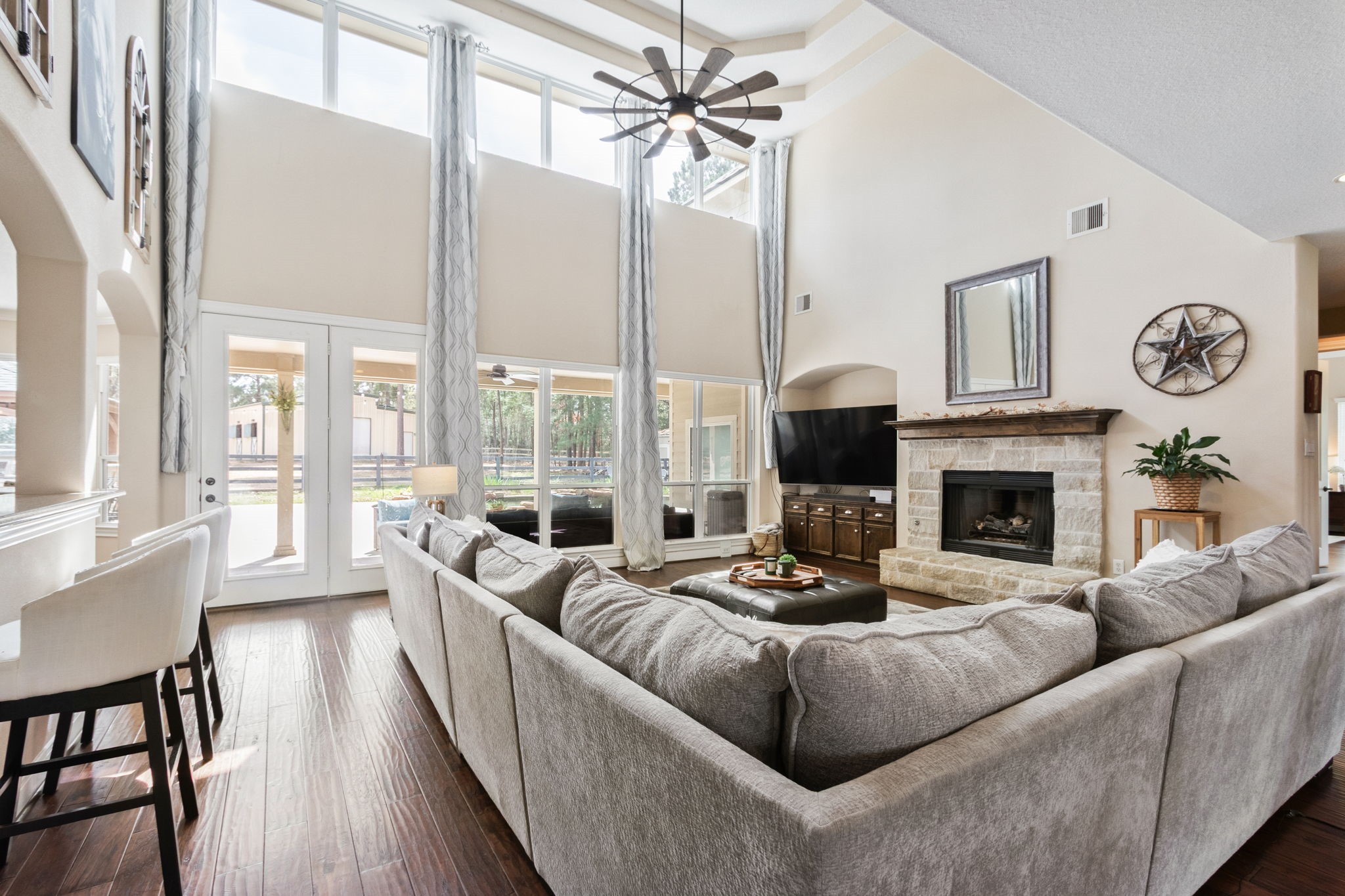 26231 Crown Ranch Boulevard Montgomery, TX 77316 - Photo 10 of 46 a living room with furniture fireplace and large windows