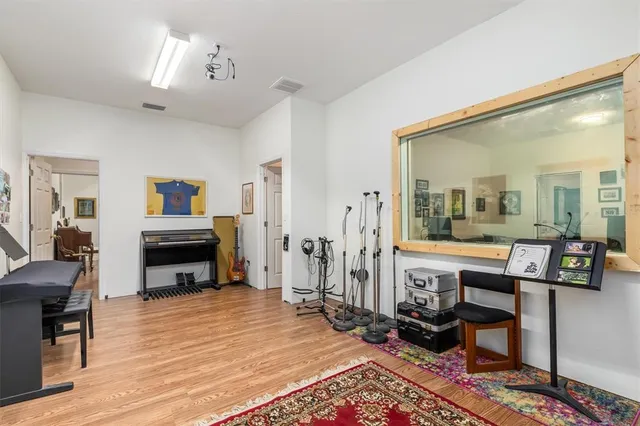a bedroom with furniture and a flat screen tv
