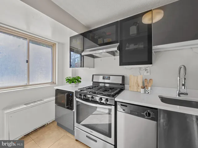a kitchen with stainless steel appliances a stove and a sink