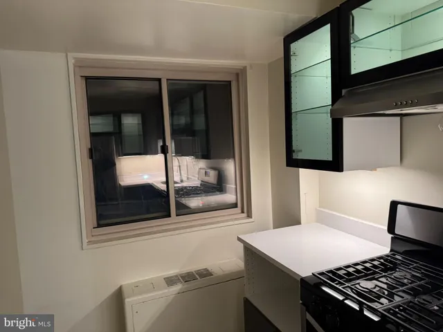 a room with a stove and a cabinet