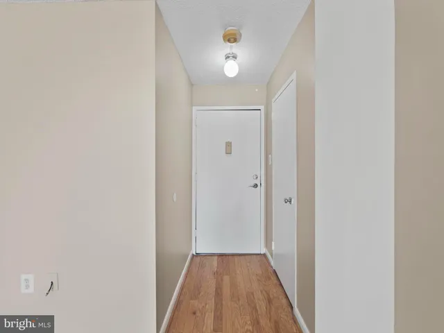 a view of a hallway with wooden floor