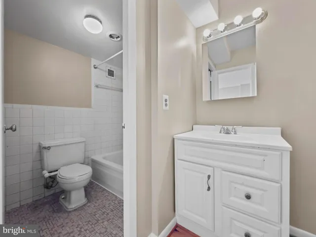 a bathroom with a sink a toilet a mirror and vanity