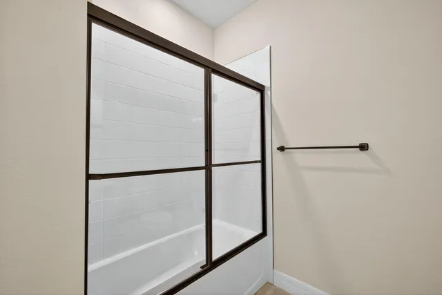 a living room with furniture a flat screen tv and a window