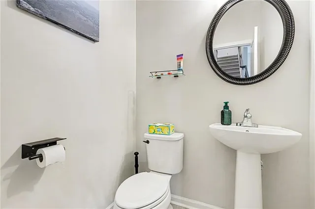 a bathroom with a sink mirror and toilet