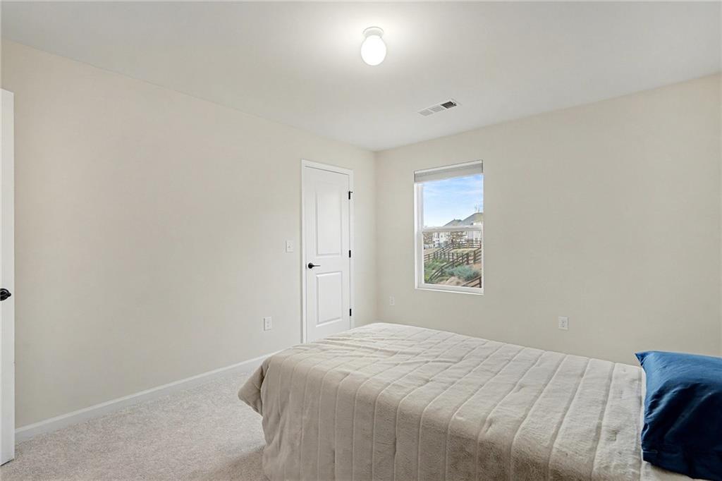 310 Coppergate Court Canton, GA 30115 - Photo 16 of 32 a bedroom with a bed and a window