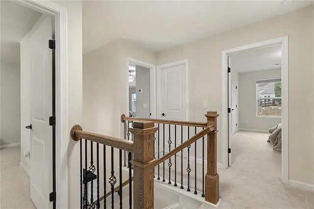 a view of a hallway with windows and stairs