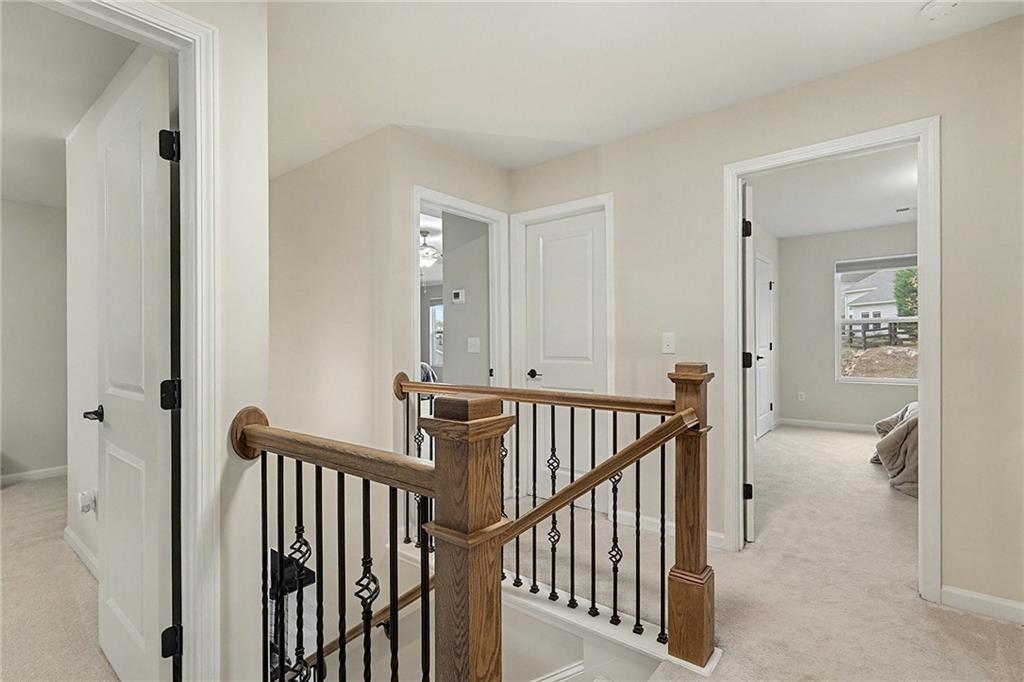 310 Coppergate Court Canton, GA 30115 - Photo 17 of 32 a view of a hallway with windows and stairs
