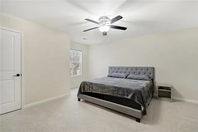 a spacious bedroom with a bed and window