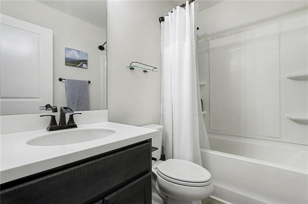 310 Coppergate Court Canton, GA 30115 - Photo 22 of 32 a bathroom with a sink a toilet and shower