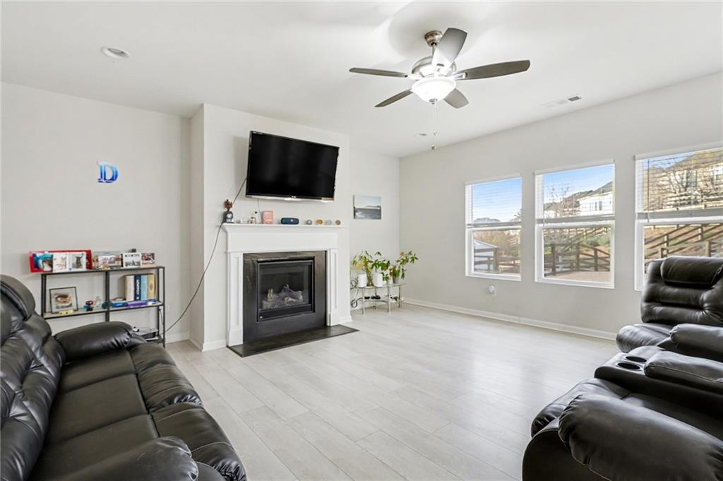310 Coppergate Court Canton, GA 30115 - Photo 4 of 32 a living room with furniture a flat screen tv and a fireplace