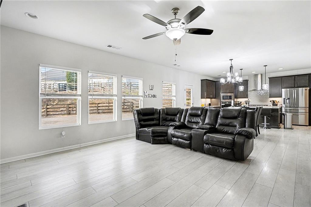 310 Coppergate Court Canton, GA 30115 - Photo 6 of 32 a living room with furniture kitchen view and a large window