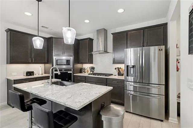 a kitchen with a table and refrigerator