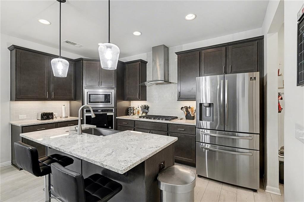 310 Coppergate Court Canton, GA 30115 - Photo 10 of 32 a kitchen with a table and refrigerator
