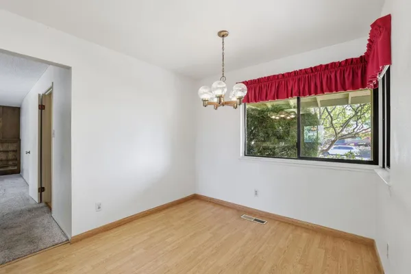 an empty room with a ceiling fan and a window