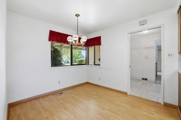 an empty room with a ceiling fan and a window