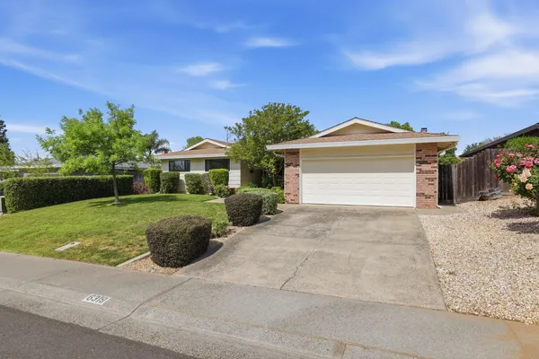 a view of house with outdoor space and garden
