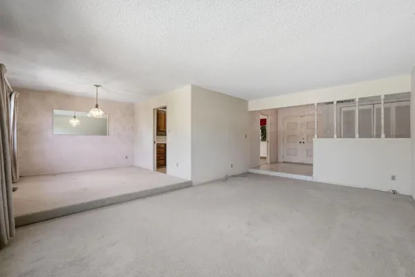 a view of a big room with windows and entryway
